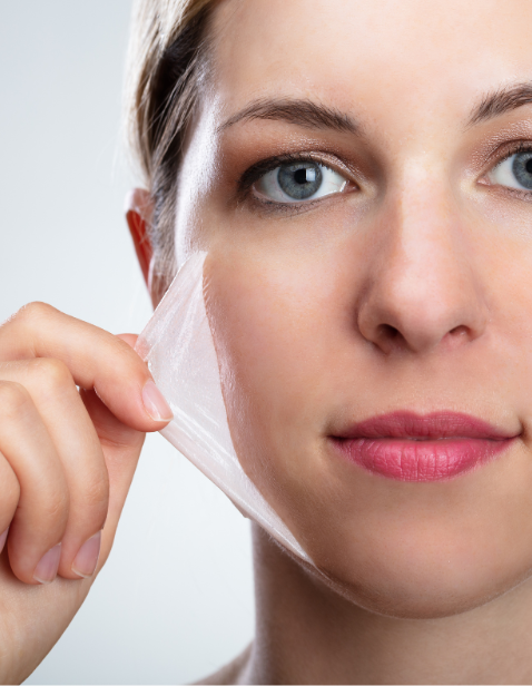 woman peeling mask from her face