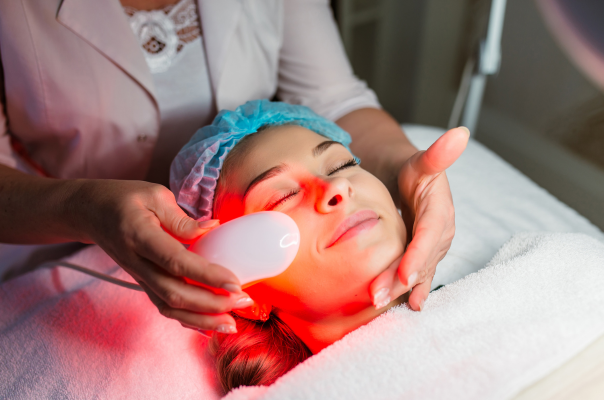 woman smiling and receiving laser treatment
